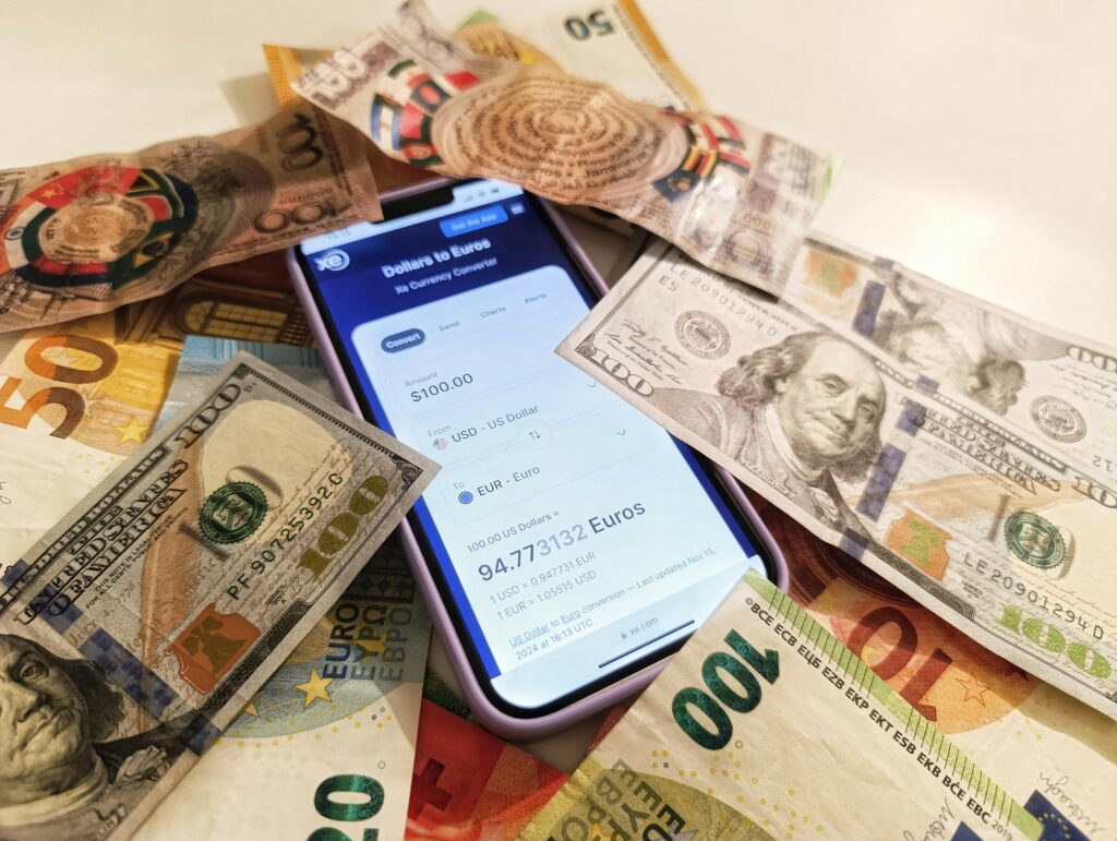 This image is showing currency and a mobile calculator is lying on the table